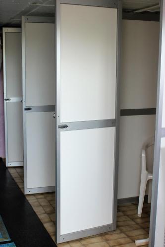 a white closet with two refrigerators in a room at Stora Djulö Vandrarhem in Katrineholm