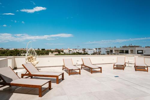 a group of chairs sitting on top of a roof at Eleia Domos in Monopoli