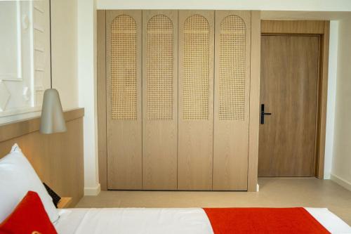 a bedroom with a closet with a bed and a door at Hotel Skanderbeg in Golem