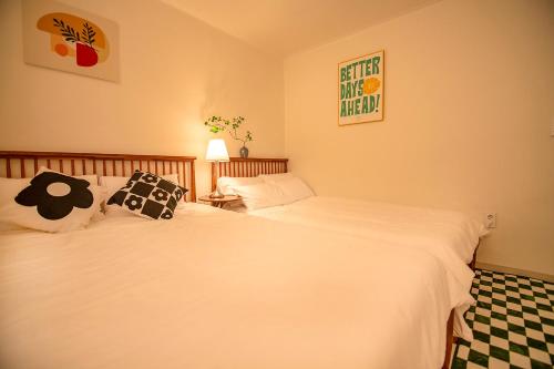 two twin beds in a room with at ANNA Stay in Seoul
