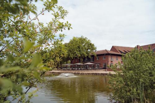 a building next to a body of water at Steigenberger Hotel Treudelberg Hamburg in Hamburg