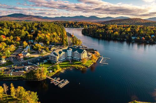 an aerial view of a resort on a lake at voco Saranac Lake NY - Waterfront by IHG in Saranac Lake