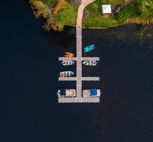 an aerial view of a dock with boats in the water at voco Saranac Lake NY - Waterfront by IHG in Saranac Lake