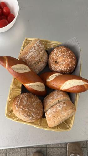 a basket of bread and bagels on a table at Klosterhof Neustadt am Main in Neustadt am Main