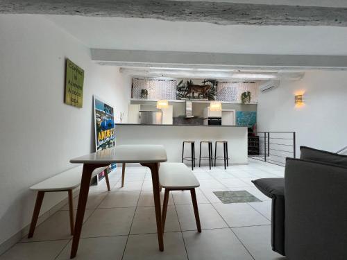 une cuisine et un salon avec une table et des chaises dans l'établissement Loft Duplex Vieil Antibes, à Antibes