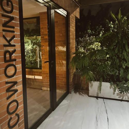 an entrance to a building with a glass door at Hotel Casa Victoria in Medellín