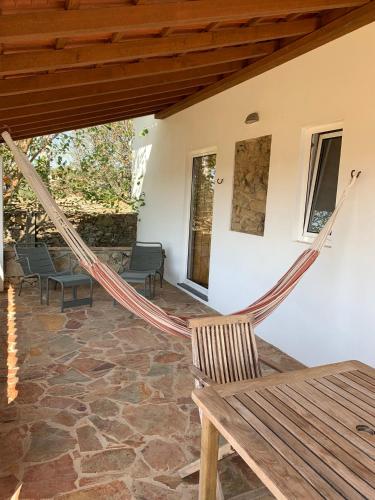a hammock on the porch of a house at Casa da Pedra-Quinta do Briando in Portalegre