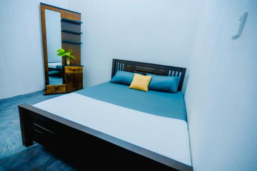 a bedroom with a large bed with a mirror at Rilu Relax villa Arugambay in Arugam Bay