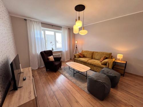 a living room with a couch and a table at Reval Residences City Center in Tallinn