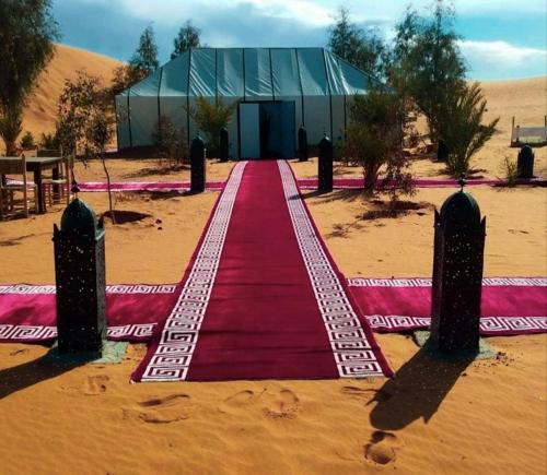 a red carpet in the middle of the desert at Desert pearl Merzouga in Merzouga