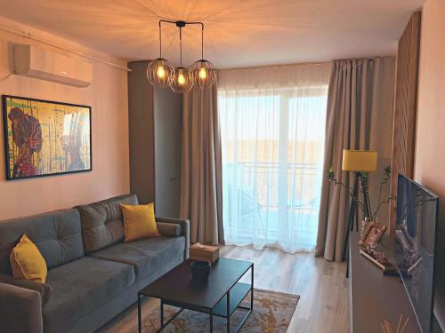 a living room with a couch and a table at Skyline Forest View Timisoara in Timişoara