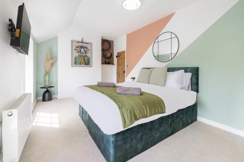 a bedroom with a large bed in a room at East Sussex Manor - Sleeps 12 - Hot Tub & Parking in Hailsham
