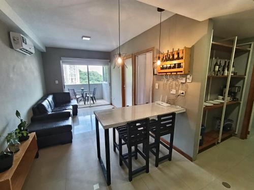 a kitchen and living room with a table and chairs at Novedoso Apartamento con Piscina y Wifi gratis in Temblador