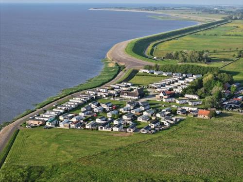 an aerial view of a parking lot next to the water at Prachtig chalet DE WADLOPER in Westerland