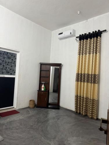 a room with a door and curtains and a window at Rilu Relax villa Arugambay in Arugam Bay