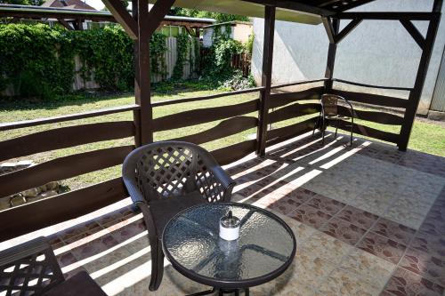 a table and chairs sitting on a patio at Panda Apartman in Hajdúszoboszló