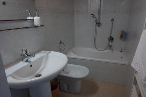 a bathroom with a sink and a toilet and a shower at Casa Orfea in Stresa