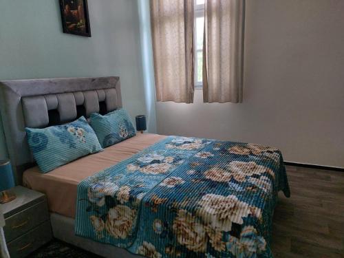 a bedroom with a bed with a quilt on it at 2bedroom Apartments in Downtown in Fès