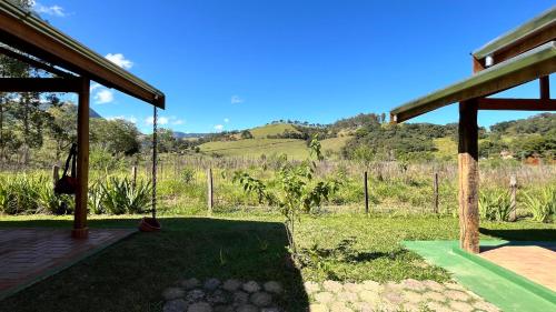 a porch of a house with a swing at Chalés Bons Ventos in São Bento do Sapucaí