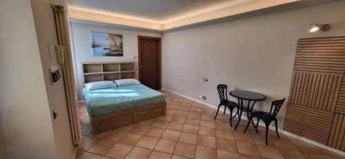 a bedroom with a bed and a table and chairs at Appartamento nel cuore di Brivio in Brivio