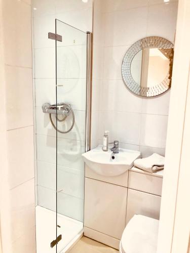 a bathroom with a shower and a sink at Peaceful Scandi Garden room in Falmouth