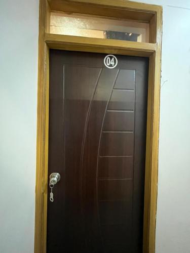 a brown door with acedes sign on top of it at Mayank Palace in Almora
