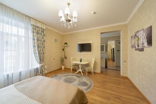 a bedroom with a bed and a table and a window at Apartment on Sumskaya 46 "Central Residence" in Kharkiv