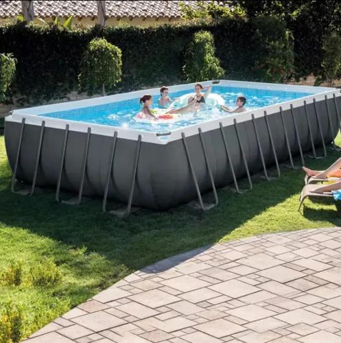 un groupe de personnes dans une piscine dans l'établissement Villa spacieuse avec piscine près de Genève, à Cercier