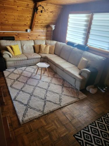 a living room with a couch and a table at Napsugár Kakasvár in Orosháza