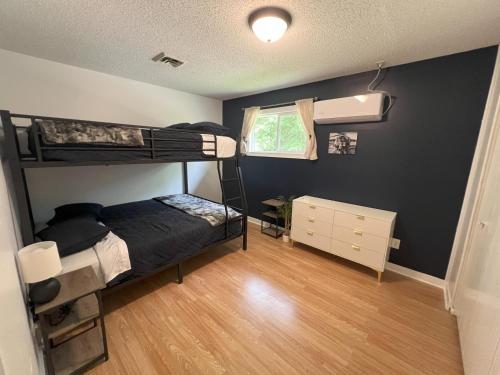 a bedroom with two bunk beds and a window at Bluebird Liberty Cottage in Saint Robert