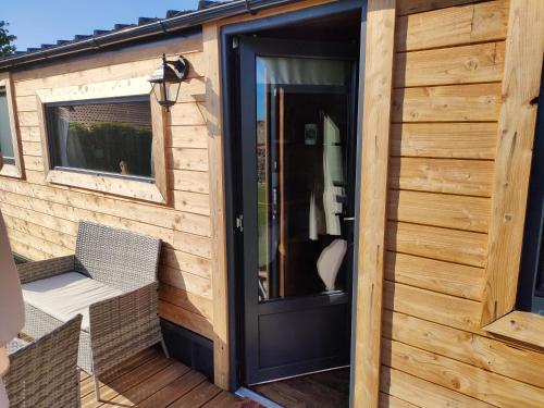 a door to a tiny house with a deck at Tiny escapade in Dombasle-devant-Darney