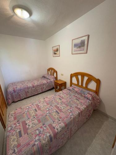 a bedroom with two beds in a room at APCOSTAS - Complejo Al Andalus in Alcossebre