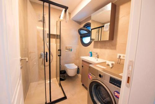 a bathroom with a shower and a washing machine at Mar Residence in Istanbul