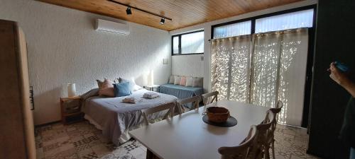 a bedroom with a bed and a table and a window at Dorrego Loft in Barraquero