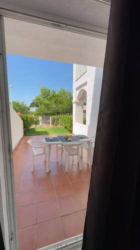 a view of a patio with a table and chairs at APCOSTAS - Complejo Al Andalus in Alcossebre