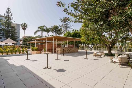 a park with a pavilion with chairs and tables at Kimpton Los Monteros Marbella by IHG in Marbella