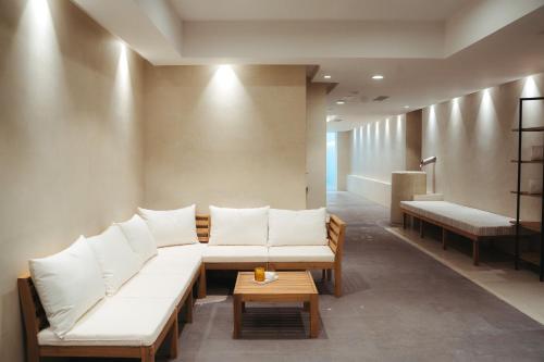 a living room with white couches and a table at Kimpton Los Monteros Marbella by IHG in Marbella