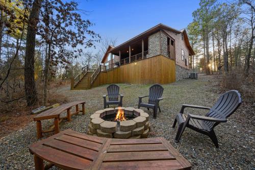 a backyard with a fire pit and chairs and a house at Twilight Pines - Dreamy Cabin w Hot Tub & optional Kids Loft in Broken Bow