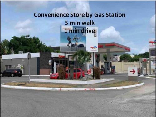 a sign in front of a gas station at Mona Studio suite in Kingston