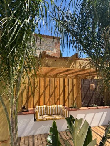 a couch sitting on top of a wooden deck at Chambre d'hôtes Villa Calys in Claira