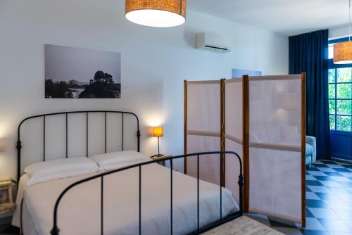 a bedroom with a bed and a lamp at AGRITURISMO 8e28 CAPALBIO in Nunziatella
