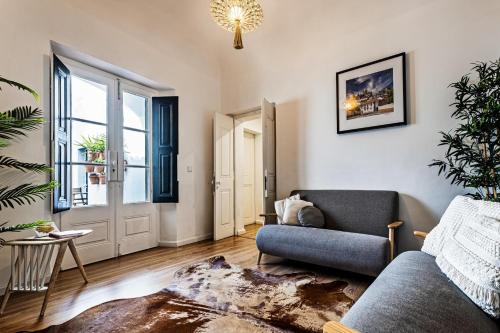 a living room with a couch and a window at Lavradores Boutique Guesthouse in Évora