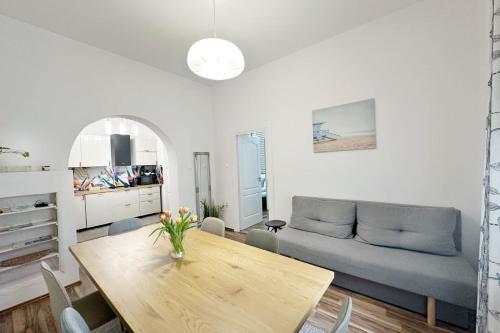 a living room with a table and a couch at Dora Holiday House & Apartments in Keszthely