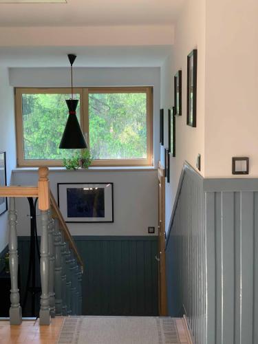 a hallway with a green staircase with a window at Piękny apartament w Pieninach in Krościenko