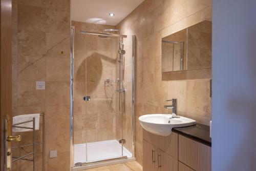 a bathroom with a shower and a sink at Old Distillery Lodge in Kingussie