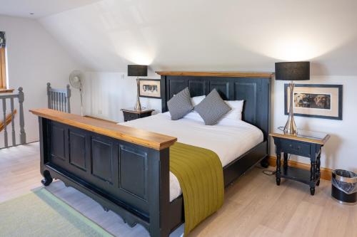 a bedroom with a bed and two lamps on tables at Old Distillery Lodge in Kingussie