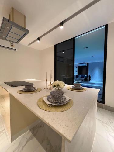 a kitchen with a table with two candles on it at Cloud Villa Salalah in Salalah