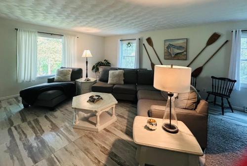a living room with a couch and a table at Breezeway Bay - Waterfront Full House in Wisconsin Dells