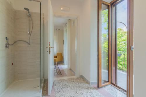 a bathroom with a shower with a glass door at Lake Lovers Lodge in Montefiascone