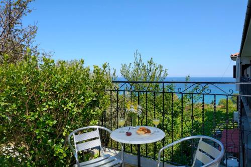 a table with a plate of food on a balcony at Hotel Agnadi - Horefto in Chorefto